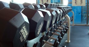 Rows of free-weight dumbbells on a weight rack 